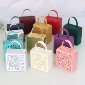Laser-cut hollow candy boxes shown in 11 colors with intricate floral petal patterns