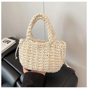 Close-up of thick beige hand-woven cotton rope bucket bag with drawstring closure