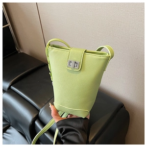 Detailed macro view of the lime green lychee pattern leather and silver metal twist lock