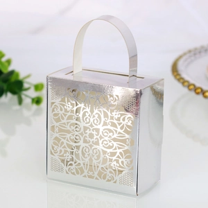 Macro shot of a silver laser-cut lace candy box with elegant floral patterns and handle