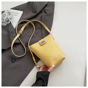 Close-up of yellow pebble leather crossbody phone bag with silver twist-lock and fine stitching