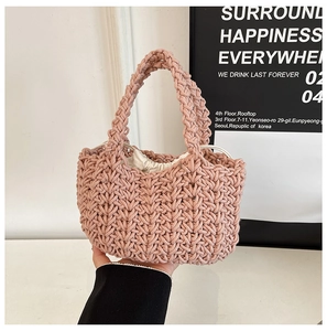 Detail of hand-woven dusty rose bucket bag with a beige canvas drawstring inner lining