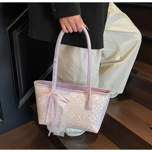 Detail of lavender textured tote bag with elegant lace bow and geometric pattern fabric