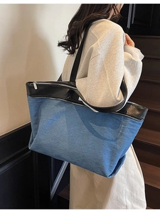 Blue denim tote bag with black faux leather straps, spacious stylish shoulder bag for daily use