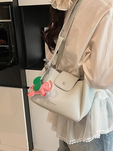 Stylish light blue pebbled leather bucket bag with cute elephant charm and metal buckle