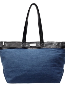 Denim tote bag with black leather straps and silver zipper for 2026 spring fashion style