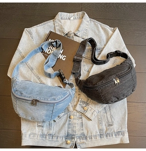 Flat lay of denim crossbody bags in blue and grey with adjustable straps on wood background