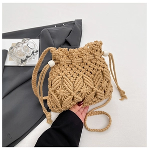 Detail of hand-woven straw bucket bag featuring diamond patterns and drawstring beads