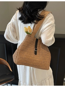 Chic brown woven straw tote bag with black leather strap and metal buckle detail