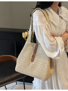 Fashionable woven straw tote bag with brown leather strap and metal buckle for women