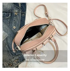 Close-up of pink crossbody bag interior showing large capacity for cosmetics
