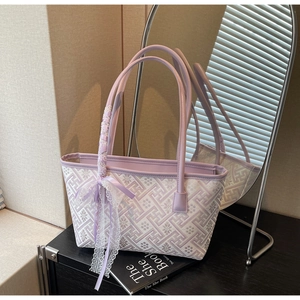 Detail of lavender tote bag with geometric patterns, lace trim and ribbon handle