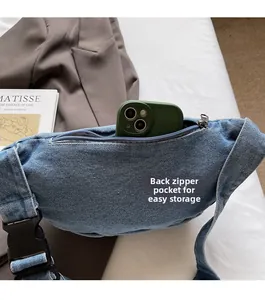 Detailed back view of denim chest bag showing secure zipper pocket with smartphone