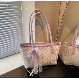Close-up of lilac and cream bucket bag featuring floral weaving and decorative silk bow
