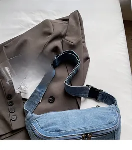 Detail of adjustable black strap and buckle on a casual denim crossbody chest bag