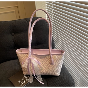 Close-up of lavender geometric jacquard bucket bag with elegant lace bow detail