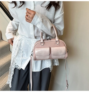 Pink bowling bag detail showing smooth flap pockets and woven texture on the front