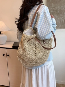 Handmade woven straw tote bag with brown leather straps for summer beach holidays