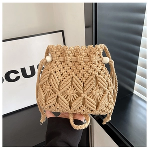 Detail of hand-woven bucket bag with drawstring closure and decorative white beads