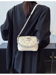 Elegant cream quilted leather crossbody bag with silver chain and twist lock closure