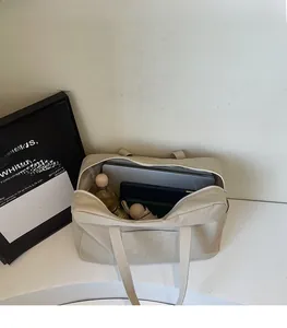 Interior view showing the large capacity of the beige tote bag with daily essentials