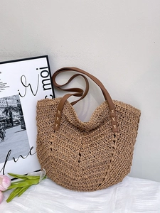 Vintage woven straw tote bag with V-shaped fishbone pattern and brown leather straps