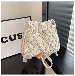 Detail of Macrame woven bucket bag featuring cotton rope texture and drawstring bead closure
