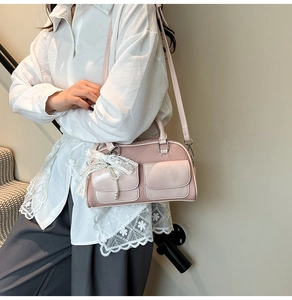 Pink striped bowling bag detail featuring delicate white lace bow and pearl pendant