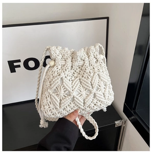 Detailed macro of handmade macramé bucket bag with drawstring and woven patterns
