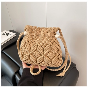 Macro shot of handcrafted macrame drawstring bucket bag with elegant wooden beads