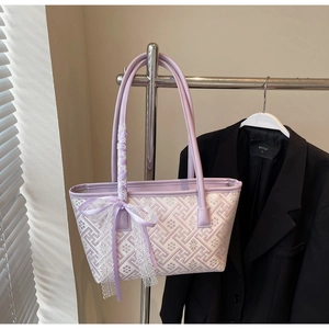 Close-up of lavender jacquard tote bag with lace bow detail and geometric pattern