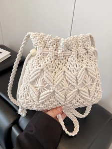 Chic beige woven macrame bucket bag with bead drawstrings and braided strap for beach vacations