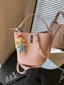 Minimalist Women Litchi Texture PU Leather Bucket Bag With Cute Cartoon Doll Charm Detachable Adjustable Shoulder Strap Handbag
