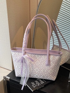 Chic lavender woven tote bag with floral patterns and a lace ribbon bow on the handle