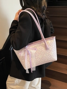Lavender geometric bucket bag with lace bow accessory shown on model's shoulder