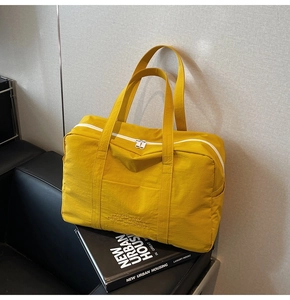 Macro shot of durable yellow nylon fabric texture and zipper detail on large travel bag