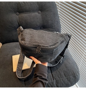 Close-up of large-capacity dark grey washed denim chest bag with multi-zipper details
