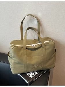 Olive green high-density nylon travel tote bag with durable white double zippers