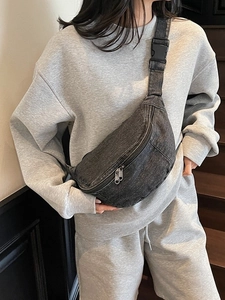 Minimalist washed denim sling bag for women in dark grey featuring adjustable strap
