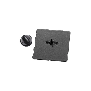 Close-up of metal badge back with sandblast texture and durable black rubber clutch