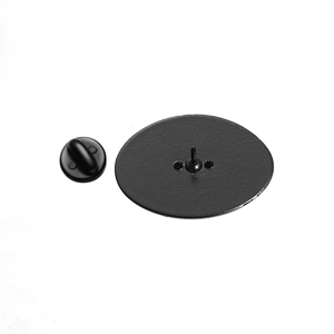 Detail of oval brooch back with metal pin and secure black rubber butterfly clutch