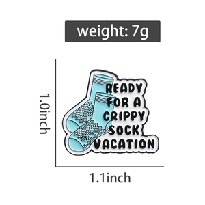 Detail view of blue grippy sock vacation enamel pin showing dimensions 1.0x1.1 inch