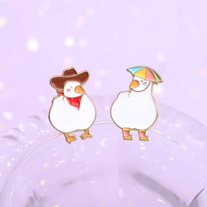 Cute white enamel duck pins set with cowboy hat and rain boots on a purple background