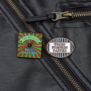 Detail of Fred Weasley and Pumpkin Pasties enamel pins on a black leather jacket