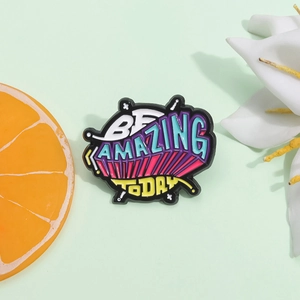 Colorful enamel brooch with BE AMAZING TODAY lettering on a mint green background
