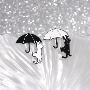Cartoon cat sleeping on umbrella enamel pin badges in black and white minimalist style