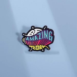 Colorful Be Amazing Today enamel brooch with pop art lettering on light blue background