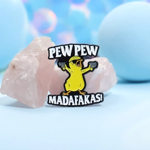 Detail of cartoon yellow duck enamel pin with sunglasses and funny pew pew text