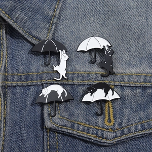 Set of four funny cartoon black and white cat umbrella enamel brooches on denim fabric