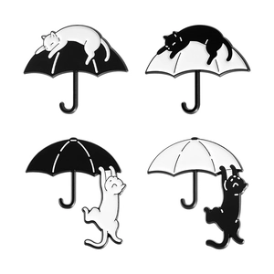 Set of four black and white cat umbrella enamel pins with creative cartoon designs